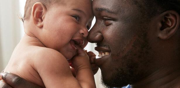 Father and baby smiling together